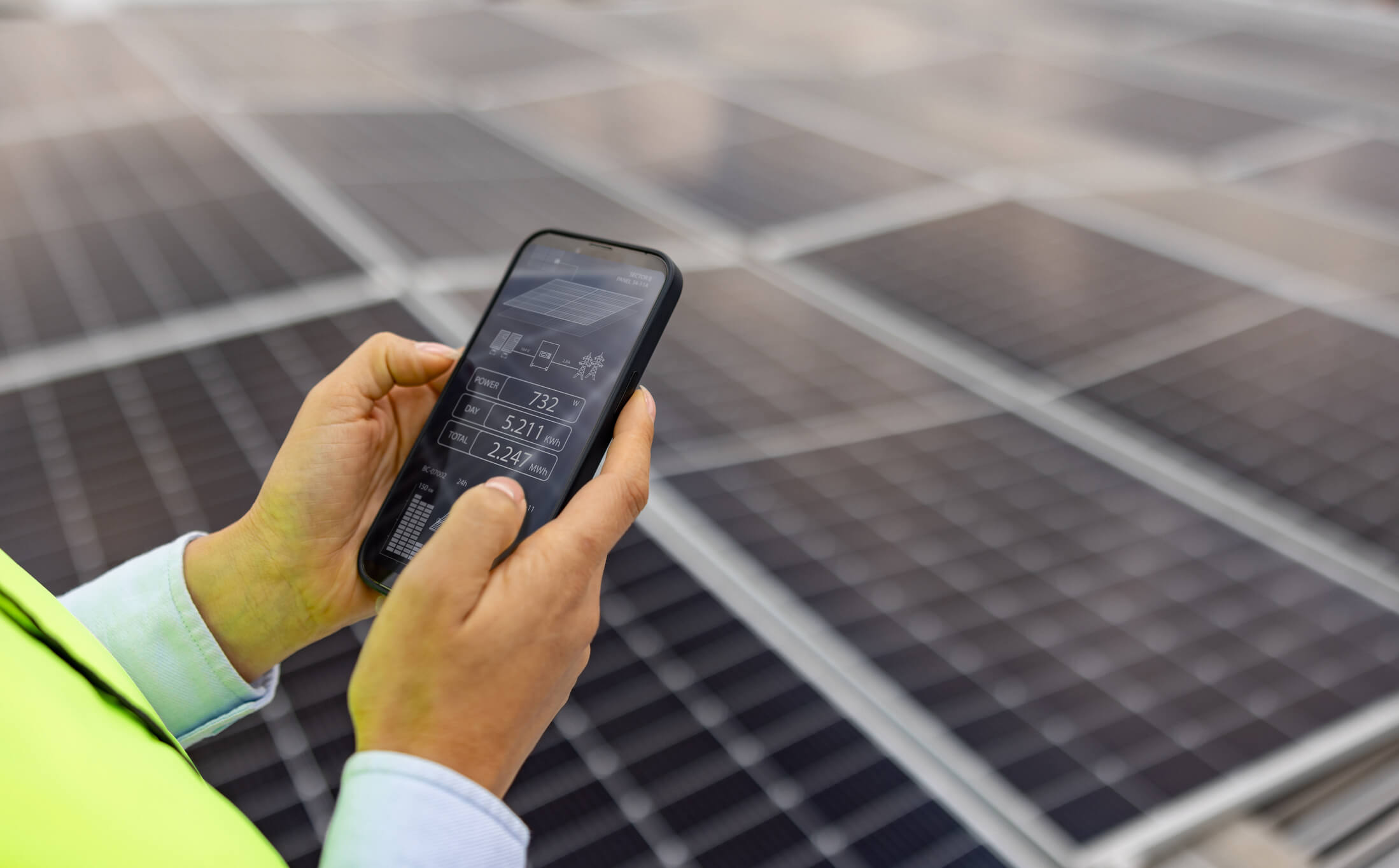 Person checking solar panels with smartphone